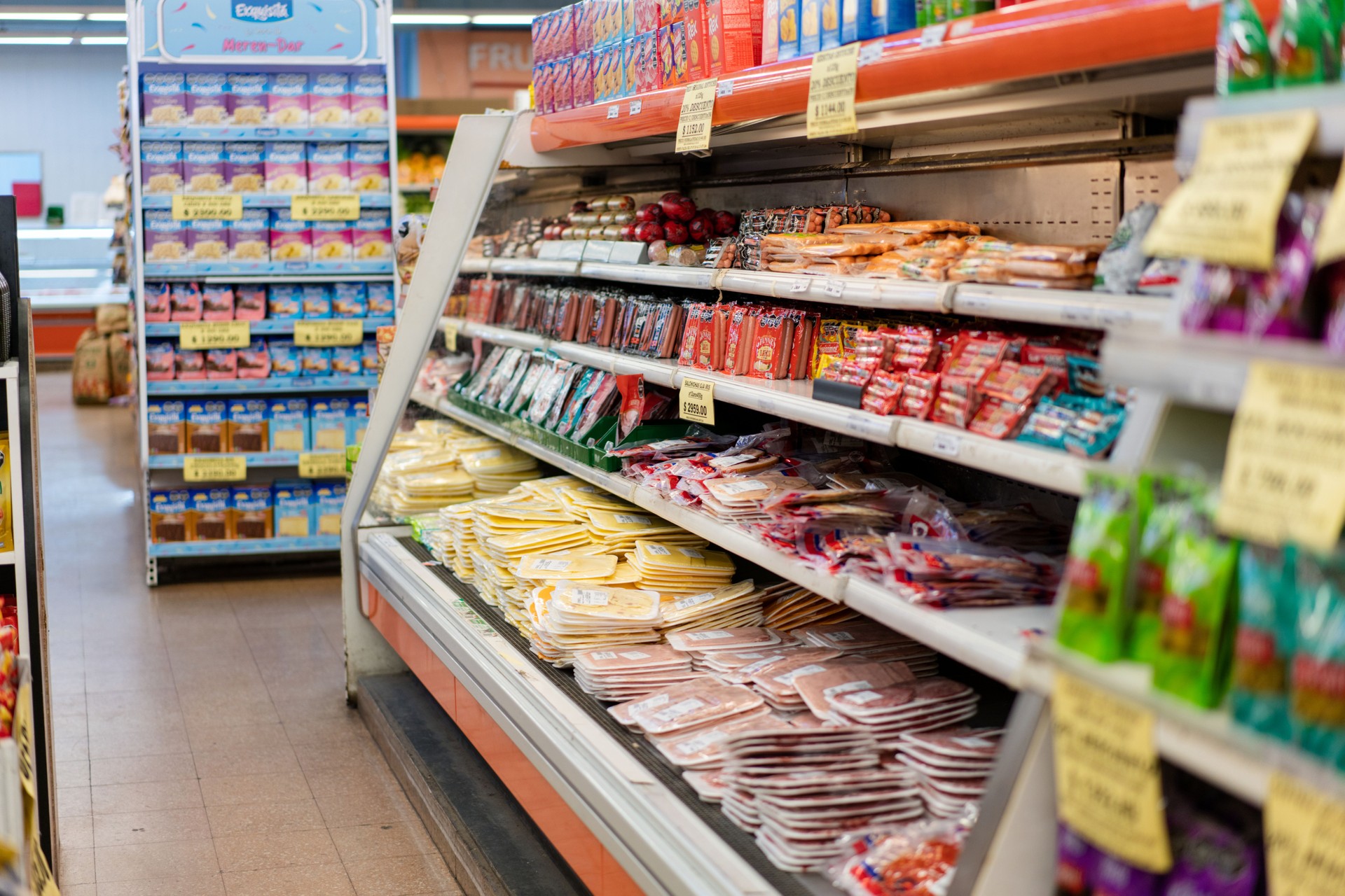 Variety of grocery items arranged on shelves in a modern supermarket