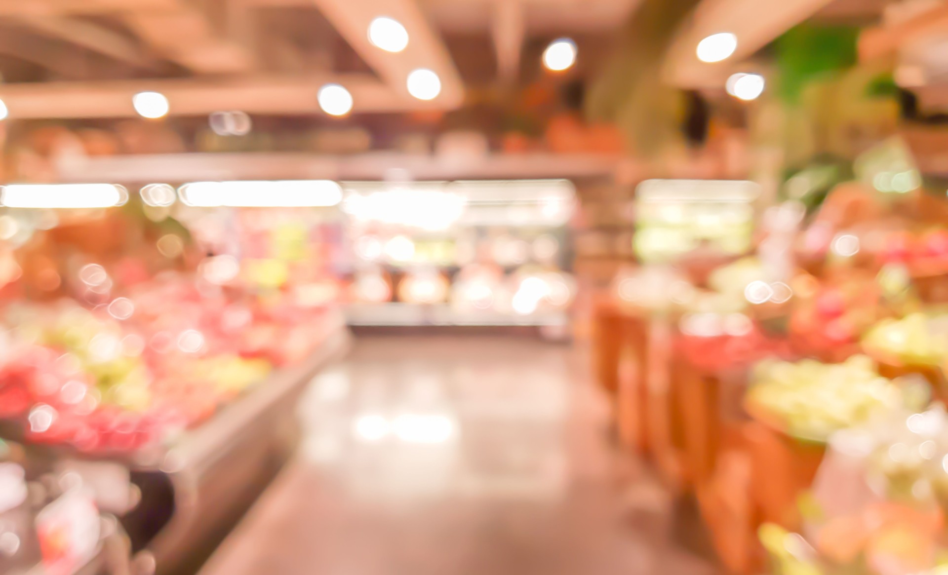 abstract blurred inside interior of local supermarket corridor path with aisle distribution shelf in vegetable and fruit zone for background design concept