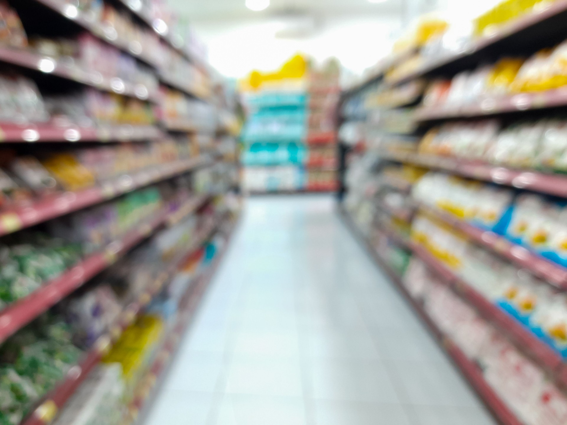 Blurred View of Supermarket Aisle with Product Shelves